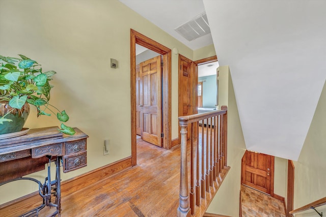 1112 Highland Rd, Salem, VA 24153 - hallway with an upstairs landing, wood finished floors, and baseboards
