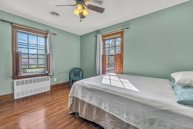 1112 Highland Rd, Salem, VA 24153 - bedroom featuring radiator heating unit, wood finished floors, baseboards, and a ceiling fan