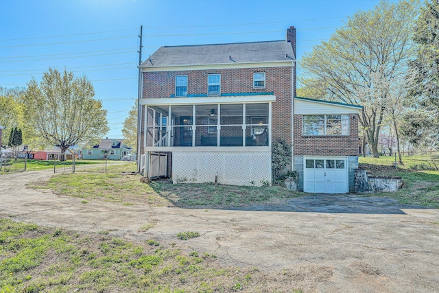 1112 Highland Rd, Salem, VA 24153 - rear view of property with a sunroom, a garage, driveway, and a chimney