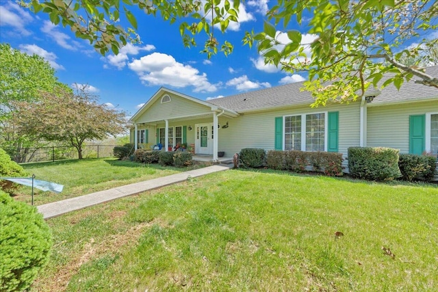 single story home featuring a front yard, a porch, and fence