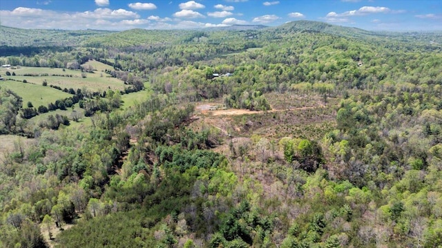 bird's eye view featuring a forest view and a mountain view