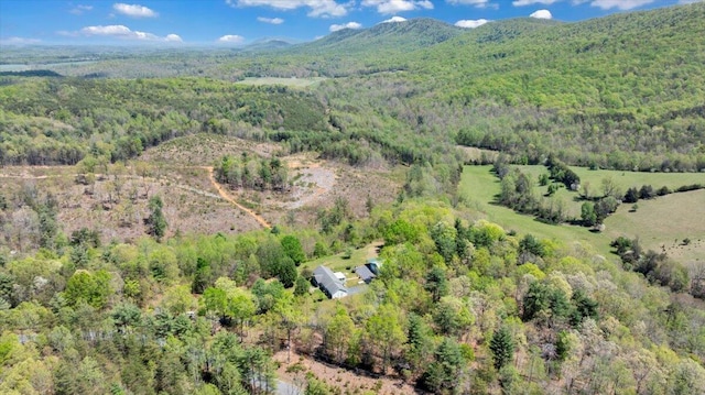 drone / aerial view featuring a forest view and a mountain view