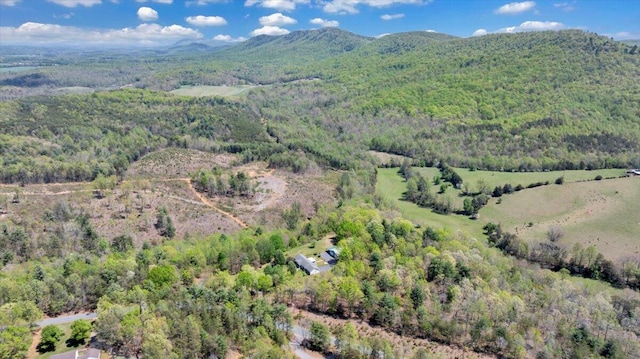 drone / aerial view featuring a mountain view and a wooded view
