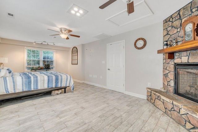 2626 Avenham Ave SW, Roanoke, VA 24014 - bedroom featuring a stone fireplace, wood finished floors, baseboards, and a ceiling fan