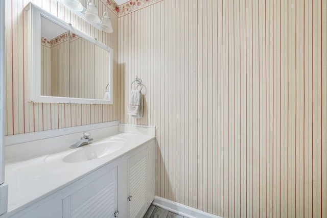 2626 Avenham Ave SW, Roanoke, VA 24014 - bathroom featuring wallpapered walls, vanity, and baseboards
