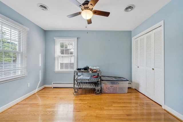 2626 Avenham Ave SW, Roanoke, VA 24014 - bedroom with a baseboard heating unit, wood finished floors, baseboards, and a closet