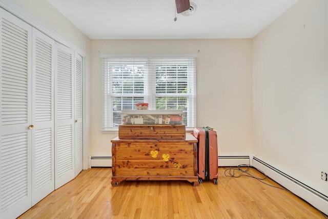 2626 Avenham Ave SW, Roanoke, VA 24014 - bedroom featuring wood finished floors, a baseboard radiator, and a closet