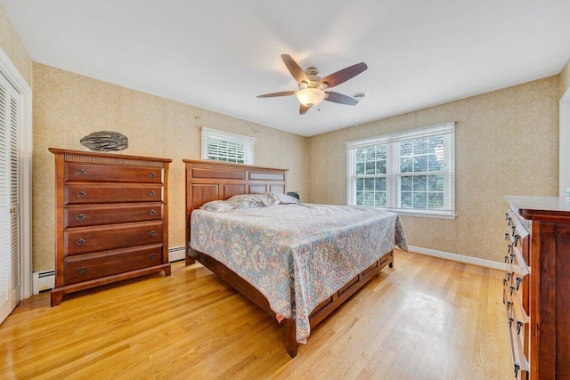 2626 Avenham Ave SW, Roanoke, VA 24014 - bedroom featuring light wood finished floors, multiple windows, a baseboard radiator, and baseboards