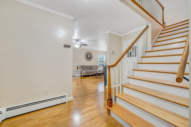 2626 Avenham Ave SW, Roanoke, VA 24014 - stairs featuring a baseboard radiator, wood finished floors, crown molding, a ceiling fan, and baseboard heating
