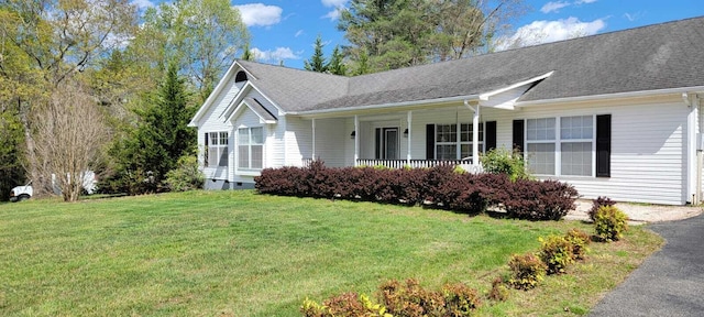 ranch-style house with a front lawn and covered porch