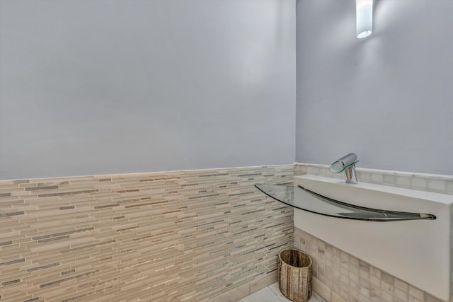 bathroom with tile walls and a wainscoted wall