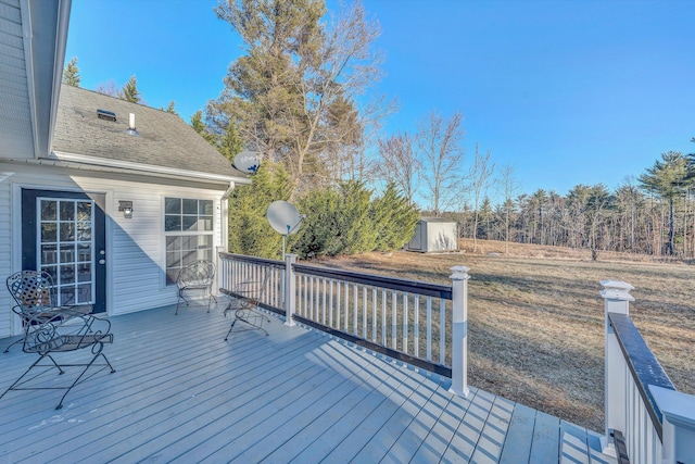 deck featuring an outbuilding and a shed