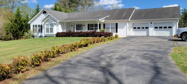 single story home featuring a front lawn, aphalt driveway, and a garage