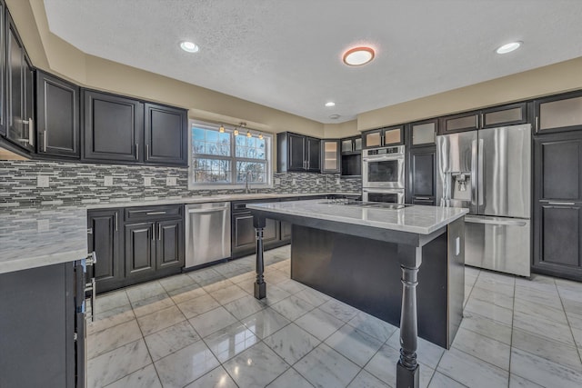 kitchen with glass insert cabinets, appliances with stainless steel finishes, a kitchen breakfast bar, and decorative backsplash