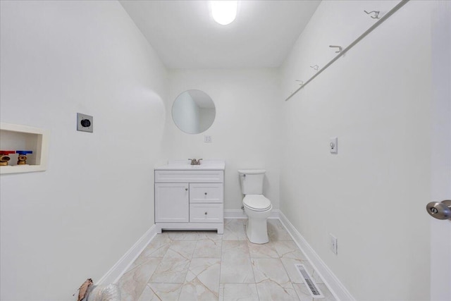 bathroom with marble finish floor, visible vents, toilet, vanity, and baseboards