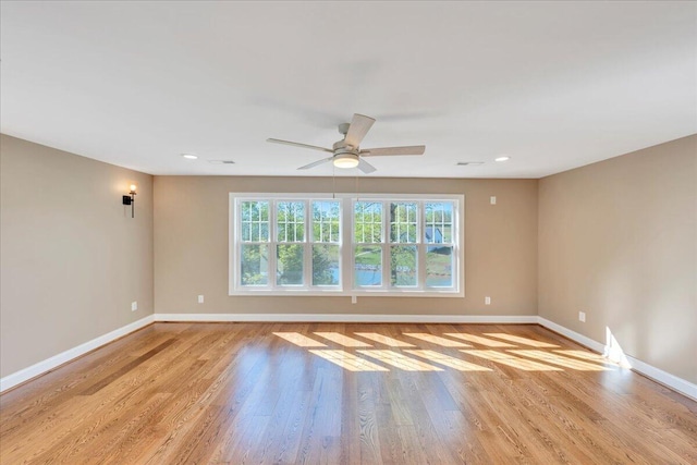 empty room featuring baseboards, recessed lighting, light wood-style floors, and ceiling fan