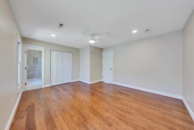 unfurnished bedroom featuring ceiling fan, light wood-style flooring, baseboards, visible vents, and recessed lighting