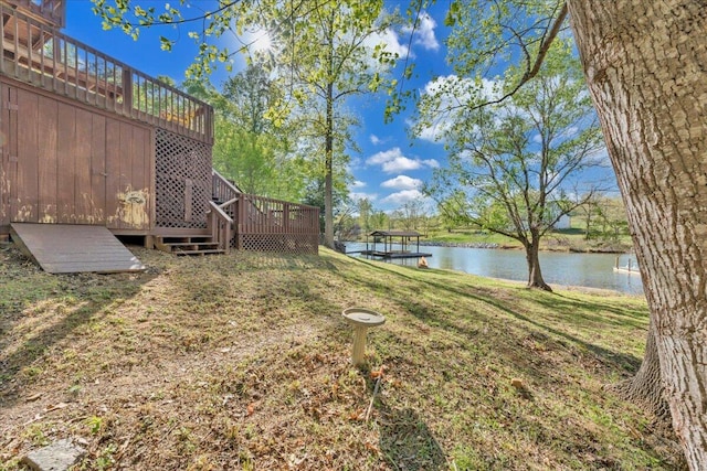 view of yard featuring a deck with water view