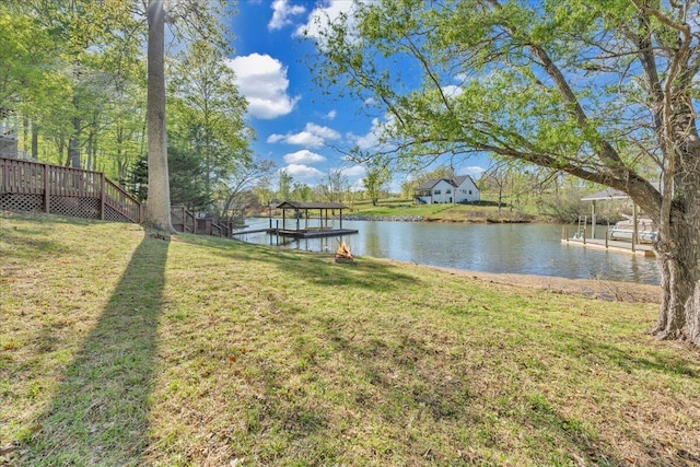 exterior space featuring a lawn and a water view