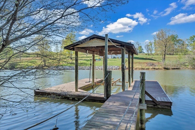 dock area with boat lift and a water view