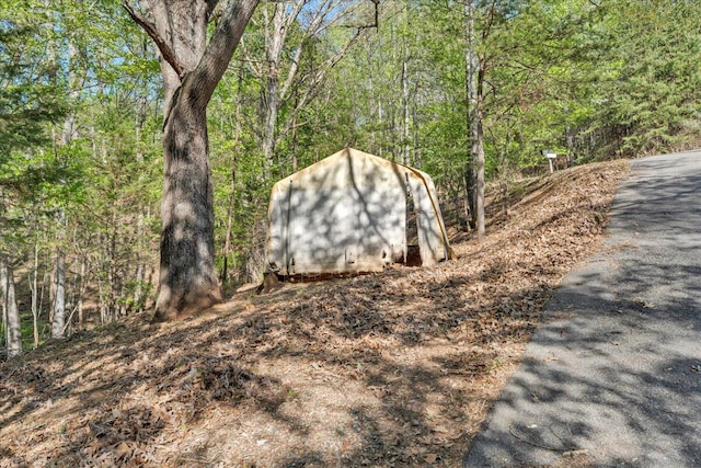 view of shed featuring a wooded view