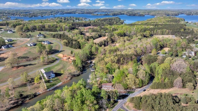 bird's eye view with a forest view and a water view
