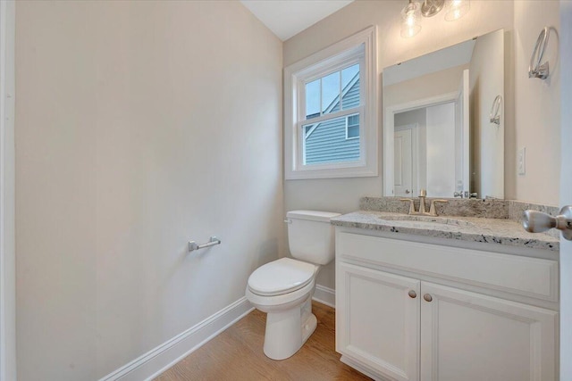 2820 Russlen Dr, Salem, VA 24153 - bathroom with baseboards, toilet, vanity, and wood finished floors