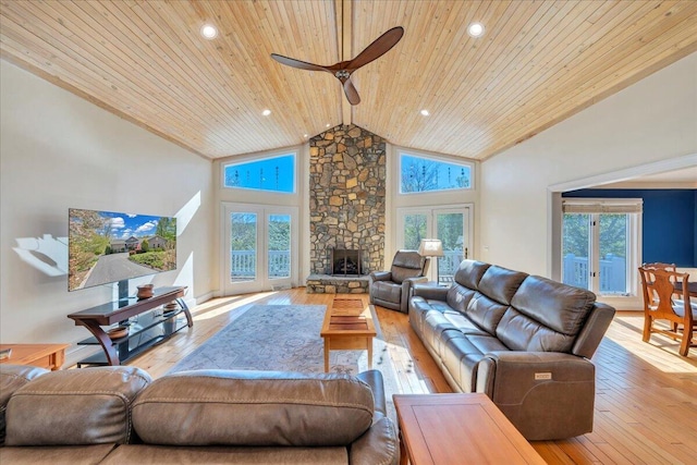 living area featuring high vaulted ceiling, ceiling fan, wooden ceiling, a fireplace, and wood-type flooring
