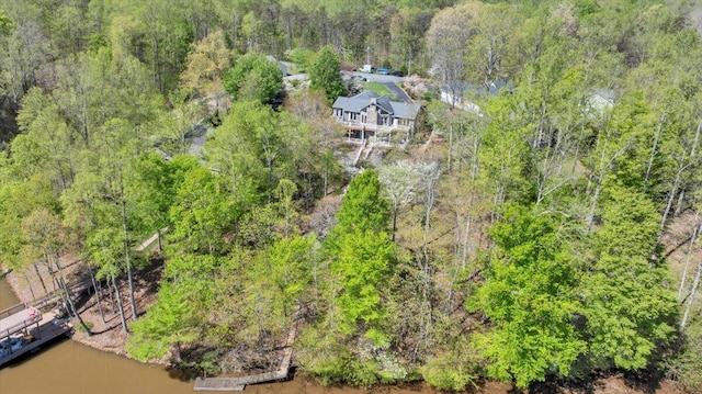 bird's eye view featuring a forest view and a water view