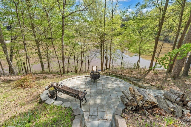 view of community featuring a patio area and an outdoor fire pit