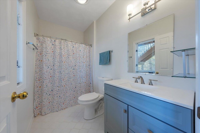 bathroom featuring a shower with curtain, vanity, tile patterned flooring, and toilet