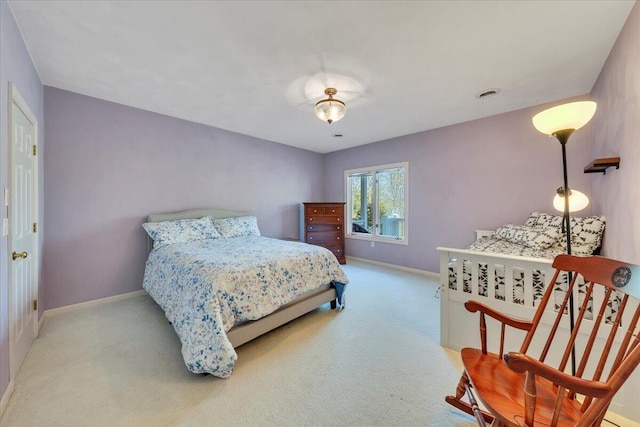 carpeted bedroom with visible vents and baseboards