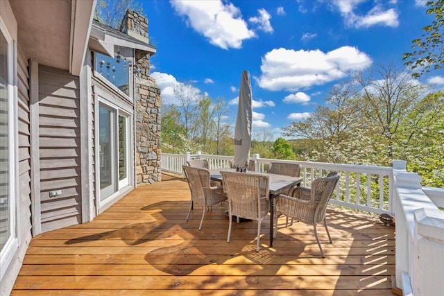 wooden terrace featuring outdoor dining space