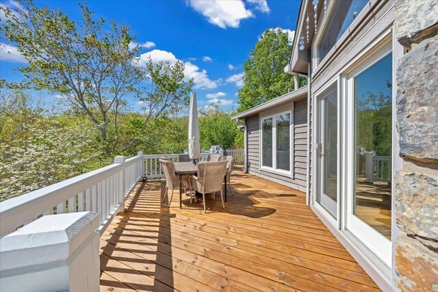 wooden terrace with outdoor dining space