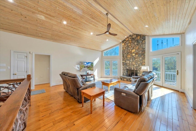 living room featuring wooden ceiling, baseboards, a ceiling fan, and light wood-style floors