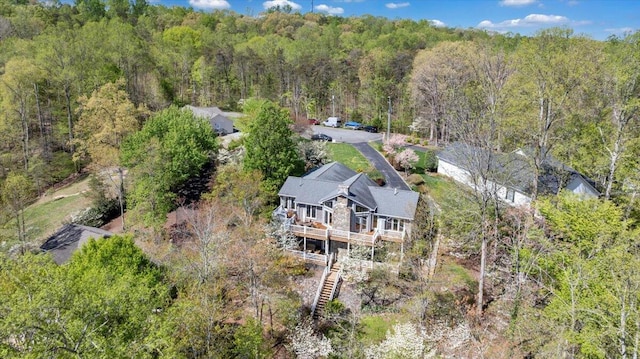 birds eye view of property with a forest view