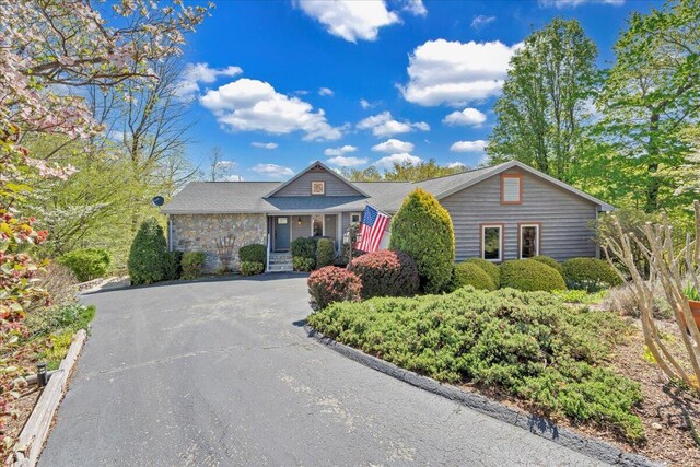 single story home featuring aphalt driveway