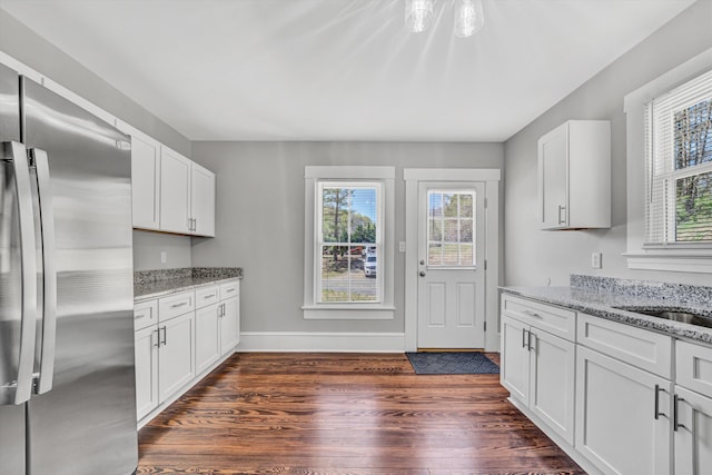 319 Trinity Rd, Troutville, VA 24175 - kitchen featuring dark wood-style flooring, a healthy amount of sunlight, light stone countertops, and freestanding refrigerator