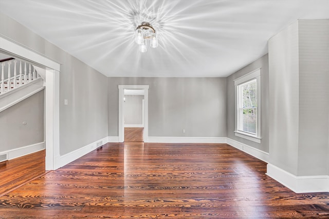 319 Trinity Rd, Troutville, VA 24175 - spare room featuring visible vents, baseboards, wood finished floors, and stairway