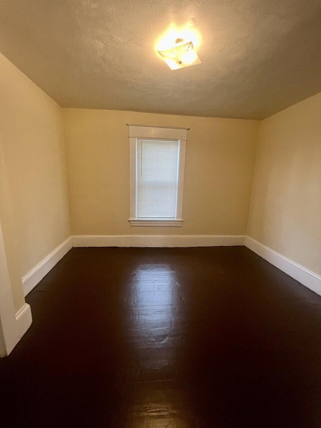 535 Madison Ave NW, Roanoke, VA 24016 - spare room featuring baseboards, a textured ceiling, and dark wood finished floors