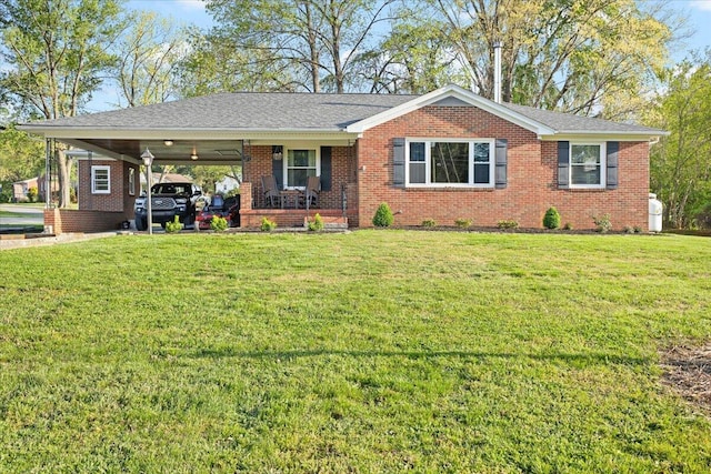 single story home with brick siding, a front lawn, and an attached carport