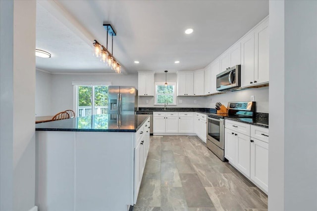 kitchen featuring white cabinetry, appliances with stainless steel finishes, and plenty of natural light