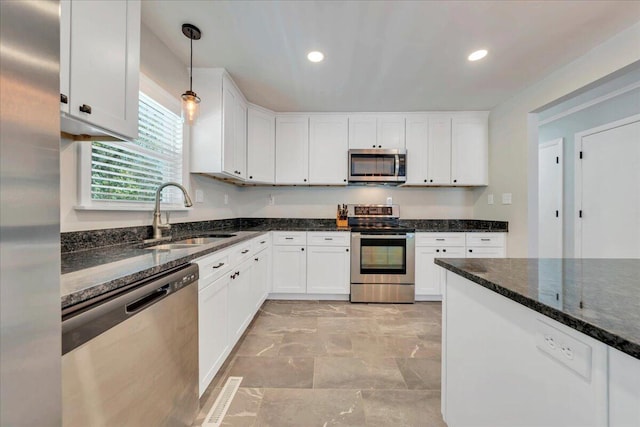 kitchen featuring white cabinetry, appliances with stainless steel finishes, and a sink