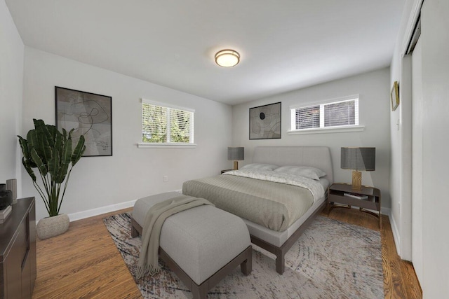 bedroom with baseboards and wood finished floors