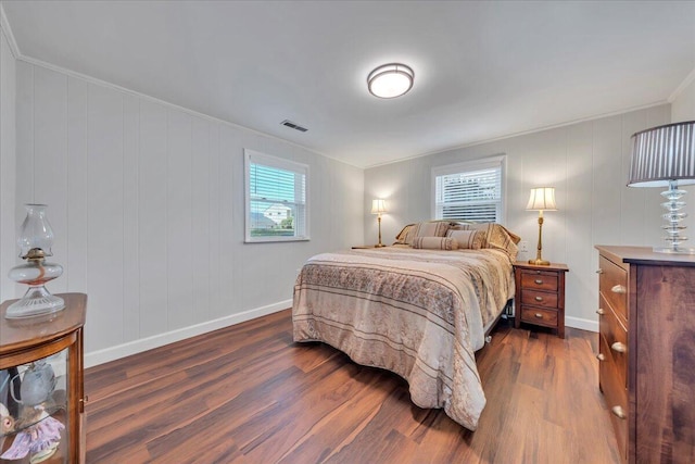 bedroom featuring dark wood finished floors, multiple windows, baseboards, and visible vents
