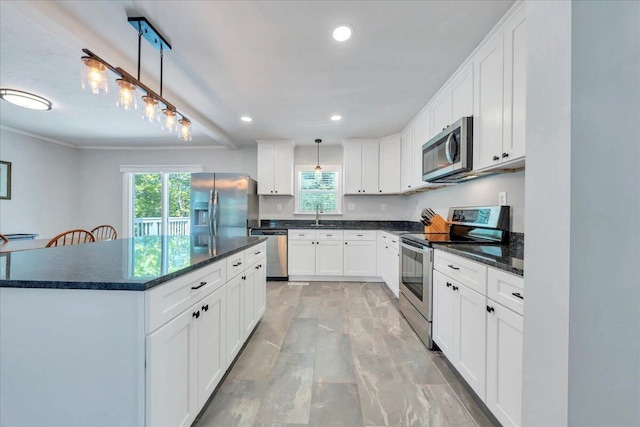 kitchen featuring recessed lighting, marble finish floor, appliances with stainless steel finishes, and plenty of natural light