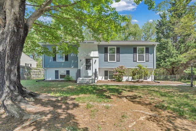 bi-level home with fence and a front yard
