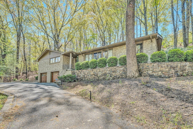 3421 Exeter St SW, Roanoke, VA 24014 - view of front of home with an attached garage, stone siding, and aphalt driveway