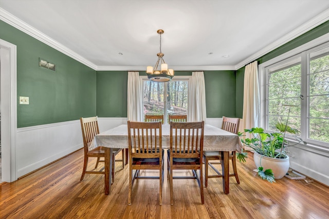 3421 Exeter St SW, Roanoke, VA 24014 - dining space with wainscoting, a wealth of natural light, ornamental molding, and an inviting chandelier