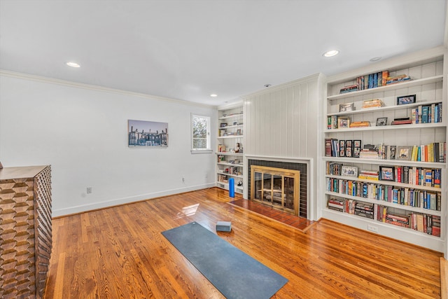 3421 Exeter St SW, Roanoke, VA 24014 - workout room with wood finished floors, a fireplace with flush hearth, built in features, baseboards, and ornamental molding